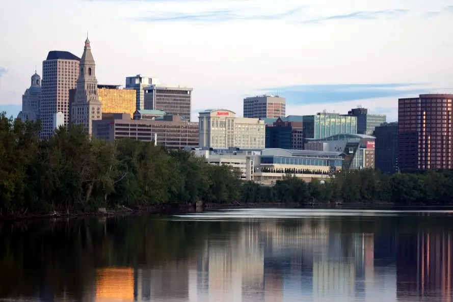 The Hartford, Connecticut skyline at dawn, reflected in the Connecticut River, photographed by Allan Camp